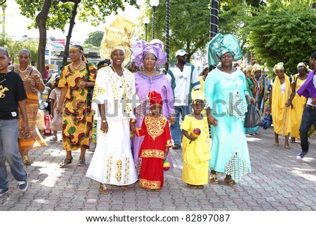 PORT OF SPAIN - AUGUST 1: unidentified kids and family celebrating Emancipation Day which commemorates the abolition of Slavery August 1, 2011 in Port Of Spain, Trinidad & Tobago. Colorful & elaborate headpieces are usually worn.
