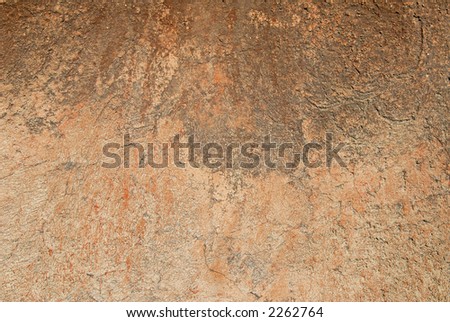 Close up detail of textured rustic terracotta stucco wall.