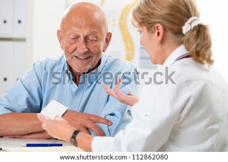 doctor talking to her male senior patient at office