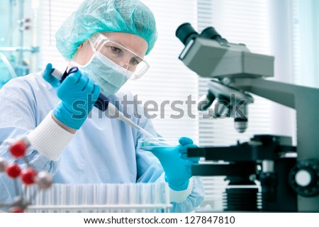 Scientist with dropper working  at the laboratory