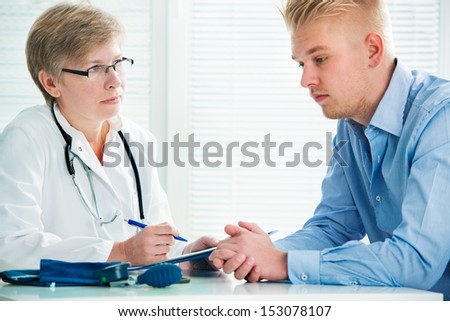 Young man visits doctors office suffering with depression
