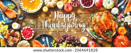 Festive turkey dinner table. Thanksgiving celebration traditional dinner concept with Happy Thanksgiving text