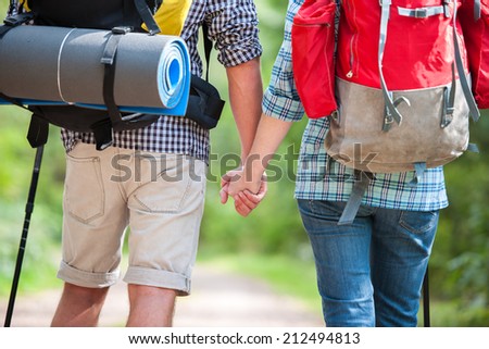 Happy couple going on a hike together in a forest