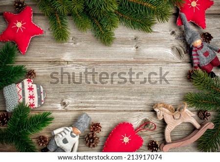 Christmas background with festive decoration and toys over wooden board