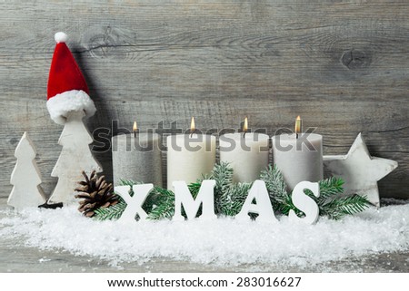 Rustic Christmas background with four advent candles burning
