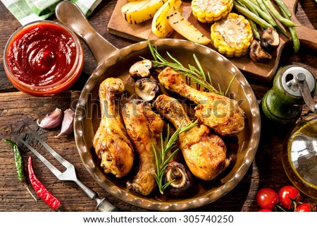 Grilled chicken drumsticks with vegetables