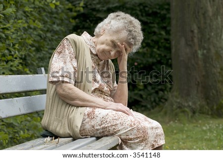 portrait of the elderly woman on the the park bench