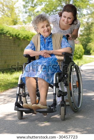Senior woman in a wheelchair with her granddaughter