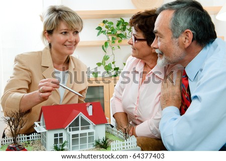 senior couple discussing  with consultant, real estate agent or architect