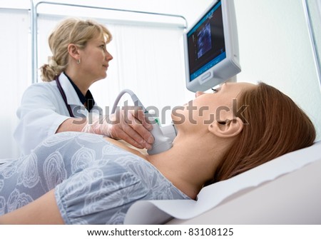 woman getting ultrasound of a thyroid from doctor