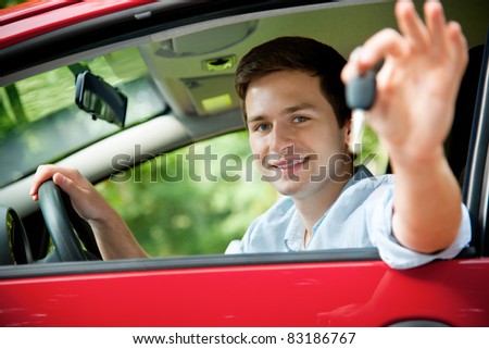 teenager sitting in new car and shows the keys