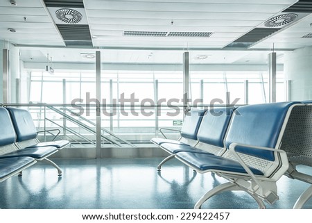 airport waiting area , seats and outside the window scene
