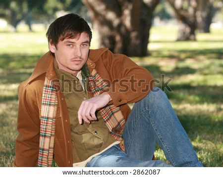 handsome country man sitting on grass