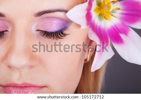 Fresh clear healthy skin on the face of beautiful woman with flower. studio portrait