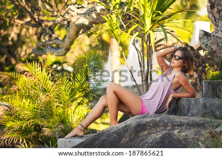 Summer girl portrait. Asian woman smiling happy on sunny summer or spring day outside in park by lake. Pretty mixed race Caucasian young woman outdoors.