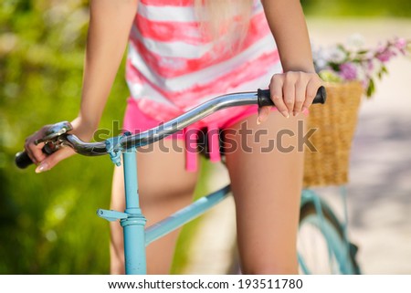 Beautiful woman\'s legs on Bicycle in Countryside, Summer Lifestyle