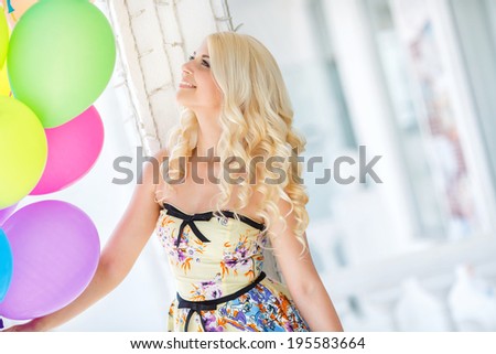 summer holidays, celebration and lifestyle concept - beautiful blonde woman with colorful balloons in the city. Bright summer portrait