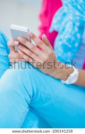 Portrait of a happy business woman texting on her phone