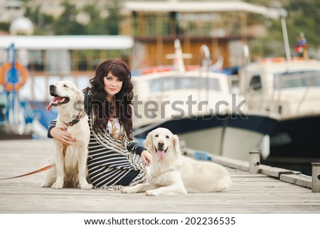 Beautiful girl with her dog near sea. Portrait of young girl with her dog.