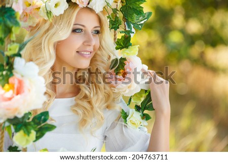 Beautiful woman with flower wreath.Beautiful women in the countryside.Portrait of beautiful young girl outdoors in spring