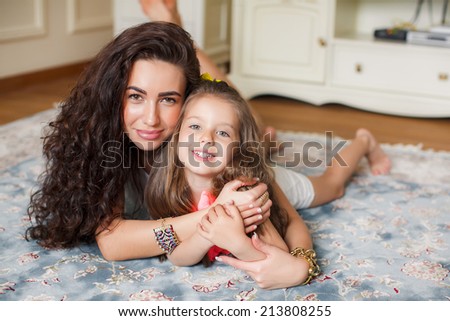 Mother And Daughter Relaxing Together. happy mother holding her child.