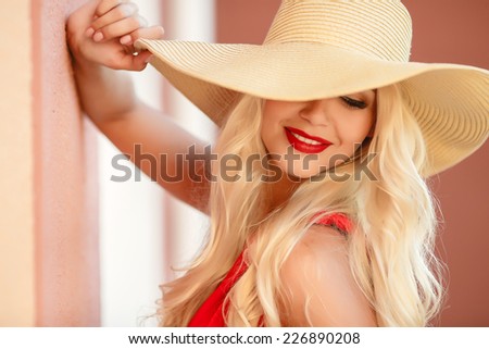 Sexy young beauty woman in red dress. beautiful fashionable blonde woman in red dress in hat with bag