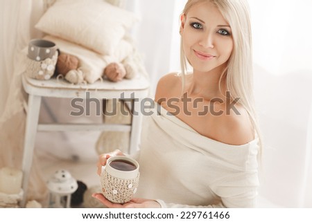 Soft photo of woman on the bed with old book and cup of coffee in hands, top view point. Cozy, comfy, soft  Home portrait of beautiful young woman, selective soft focus