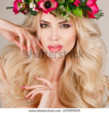 Beautiful blonde woman portrait in flower wreath. Nail art. Studio portrait. Spring flourishibg beauty. Youth. Hands and face skin care. Manicure and Makeup.