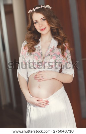 Pregnant Happy smiling Woman caressing her belly. Mom Expecting Baby. Pregnant Woman Belly. Pregnancy. Beautiful Pregnant Woman. Maternity concept. Baby Shower