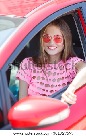Young woman in her new car smiling. Woman Sitting In Car Getting Ready To Drive. car driver woman smiling showing new car keys and car.