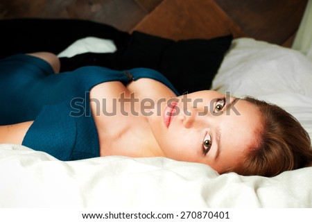 Attractive girl with beautiful body lying in bed as a symbol of beauty, seduction, sex, youth, adolescence