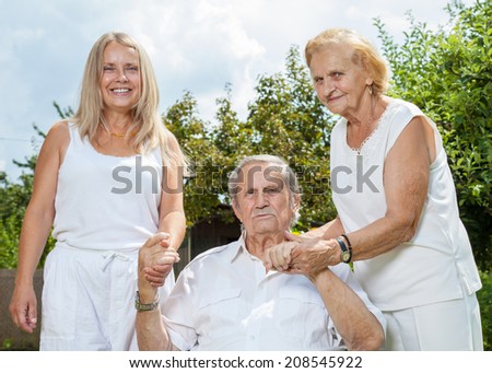 Elderly couple and their daughter outdoors