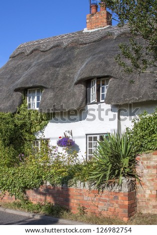 a thatched cottage in an english village