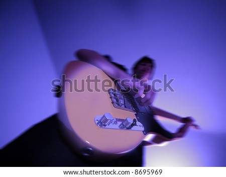 14 year old teenage boy playing punk rock on a vintage blonde fender telecaster type guitar in rehearsal room on performing arts course
