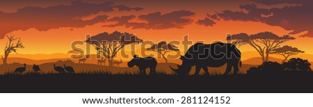 Silhouettes of african wild animals at sunset or sunrise
