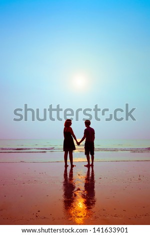 honeymoon, silhouettes of loving couple on the beach