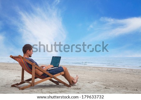 businessman working with computer on the beach