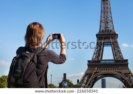tourist in Paris, woman taking photo of Eiffel Tower