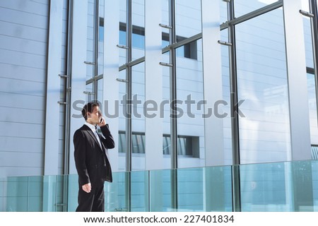 young business man talking by phone in office high tech  bright interior