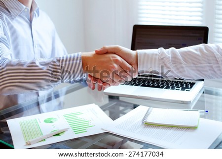 business meeting, handshake close up in office background