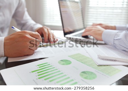 business people working in the office, focus on foreground