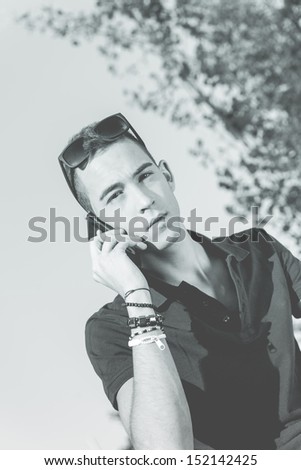 Young man with mobile phone in black and white