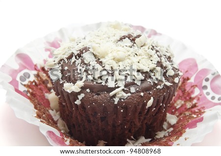 Chocolate cupcake with white chocolate chips over on white background