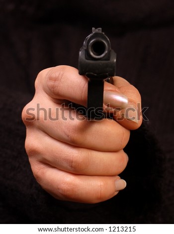 Woman holding a gun in the hand pointing to you