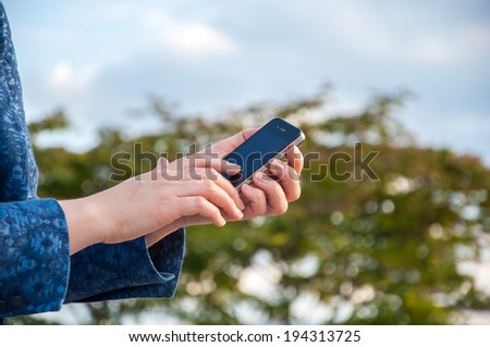 ZAGREB, CROATIA - May 19, 2014: Woman hand holding a black Apple Iphone mobile smartphone.