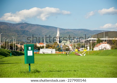 Zagreb, Croatia - October 18, 2014: Bright green dog mess poop bin with label.