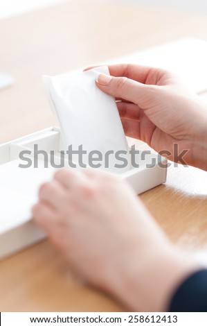 Zagreb, Croatia - January 31, 2015: Woman unpacking new Apple Magic mouse.