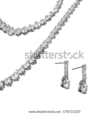 fragment of crystal pendant, bracelet  and a couple of earrings isolated on white