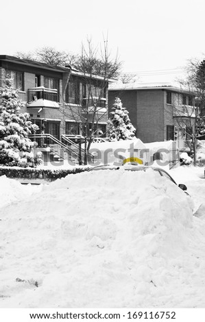 Selective color focusing on the yellow  Black and white Winter scene Taxi car buried under snow in Montreal, Quebec Canada
