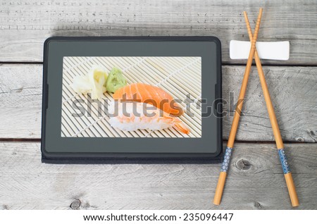 On-line and web asian food ordering concept with digital tablet and chopsticks